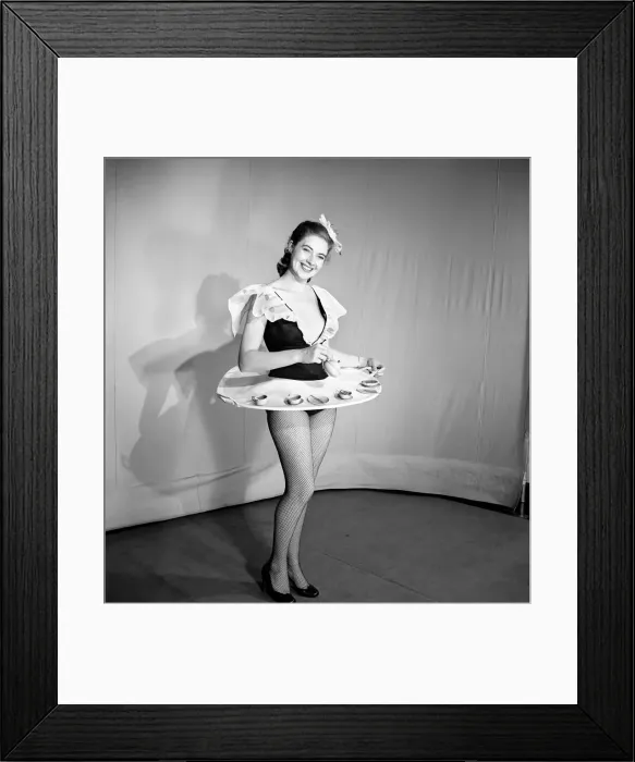 Framed Print : Woman wearing a skirt that is also a tray, seen here with tea pot and cups on the tray