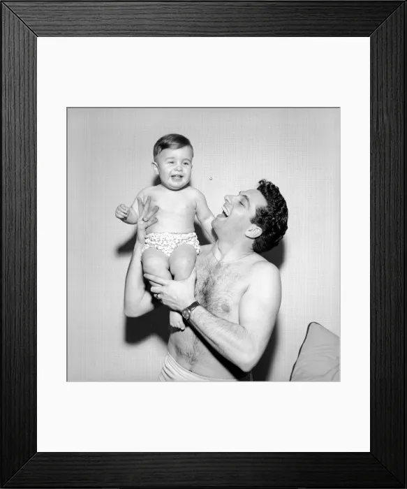 Framed Print : Singer Frankie Vaughan seen here playing with his son David. Circa 1957 Framed Print : Singer Frankie Vaughan seen here playing with his son David. Circa 1957