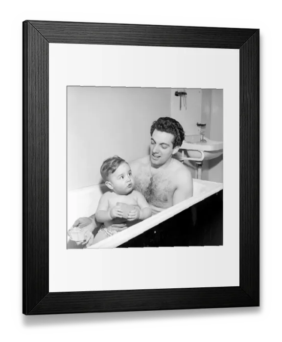 Framed Print : Singer Frankie Vaughan seen here taking a bath with his son David. Circa 1957 Framed Print : Singer Frankie Vaughan seen here taking a bath with his son David. Circa 1957