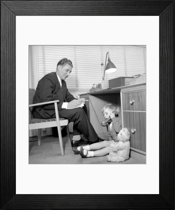 Framed Print : Office Junior: Two year old boy helps out at the offices of Theobald and son Framed Print : Office Junior: Two year old boy helps out at the offices of Theobald and son