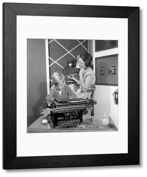 Framed Print : Office Junior: Two year old boy helps out at the offices of Theobald and son Framed Print : Office Junior: Two year old boy helps out at the offices of Theobald and son