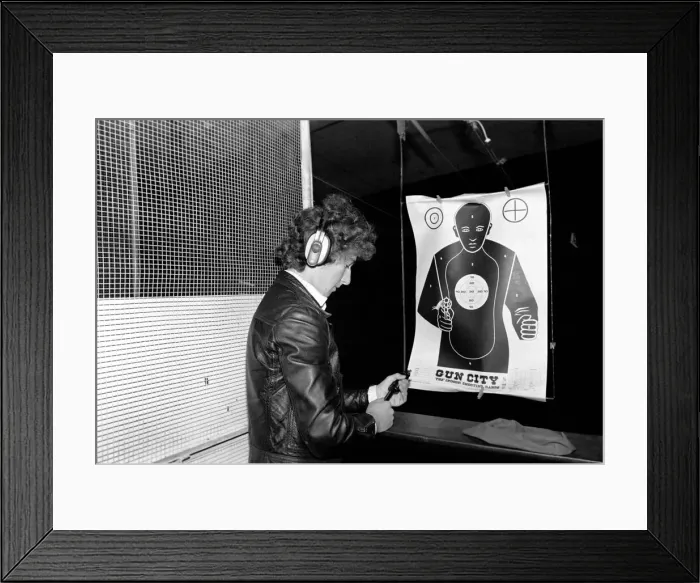 Framed Print : A man shooting at a target during practice at Gun City shooting range in South Africa Framed Print : A man shooting at a target during practice at Gun City shooting range in South Africa