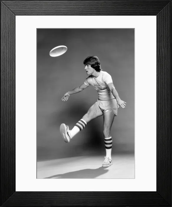 Framed Print : A man performing exercises with a frisbee. June 1980