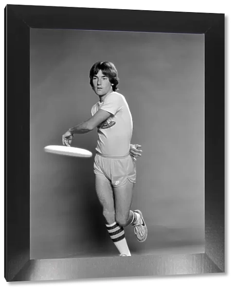 A man performing exercises with a frisbee. June 1980