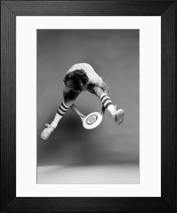 Framed Print : A man performing exercises with a frisbee. June 1980 Framed Print : A man performing exercises with a frisbee. June 1980