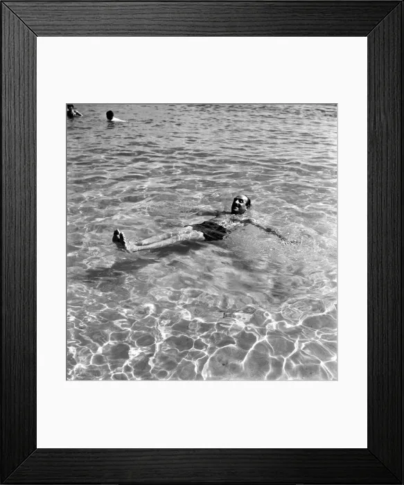 Framed Print : Holidays: Man enjoying the beach on Corsica. August 1957 A503a-009