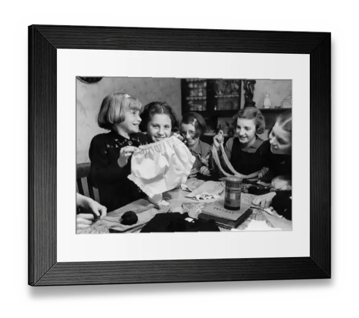 Framed Print : Young girls showing off one of six pairs of knickers that they made from an old night