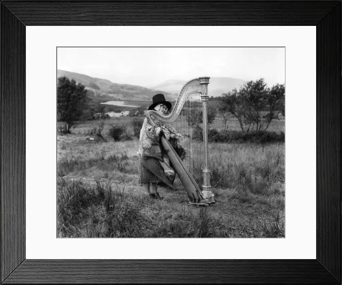 Framed Print : A Harpist wearing traditional Welsh National dress. Circa 1920 Framed Print : A Harpist wearing traditional Welsh National dress. Circa 1920