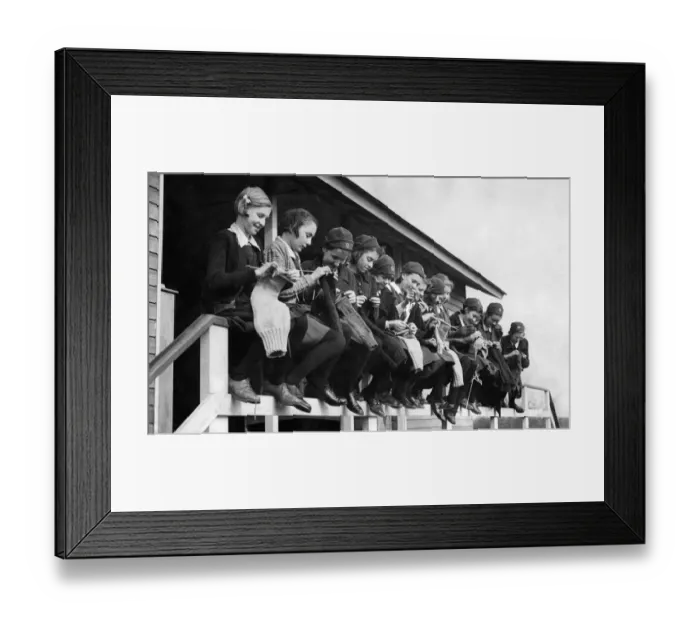 Framed Print : Girls at the Finnermore wood camp huts are here seen knitting sea stockings