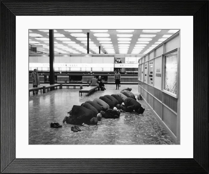 Framed Print : While they wait for their flight, Moslem pilgrims bound for Mecca take their shoes off Framed Print : While they wait for their flight, Moslem pilgrims bound for Mecca take their shoes off