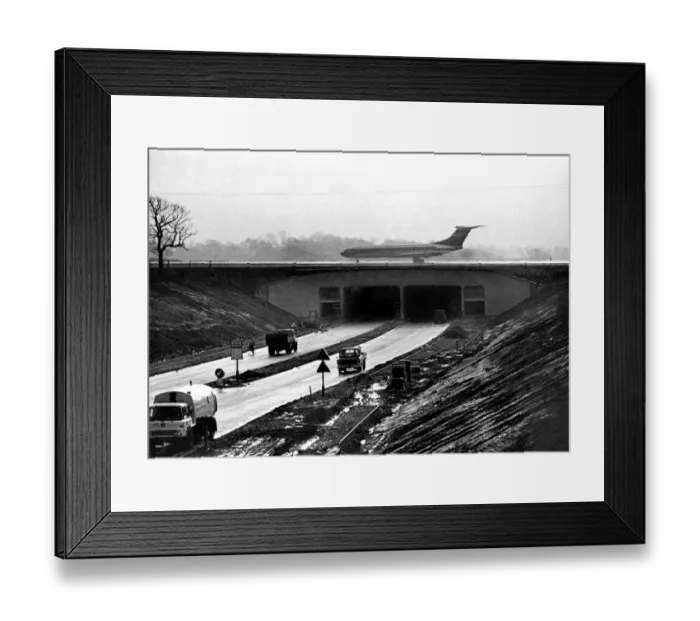 Framed Print : An airliner on Manchester Airports new main runway extension which bridges Framed Print : An airliner on Manchester Airports new main runway extension which bridges