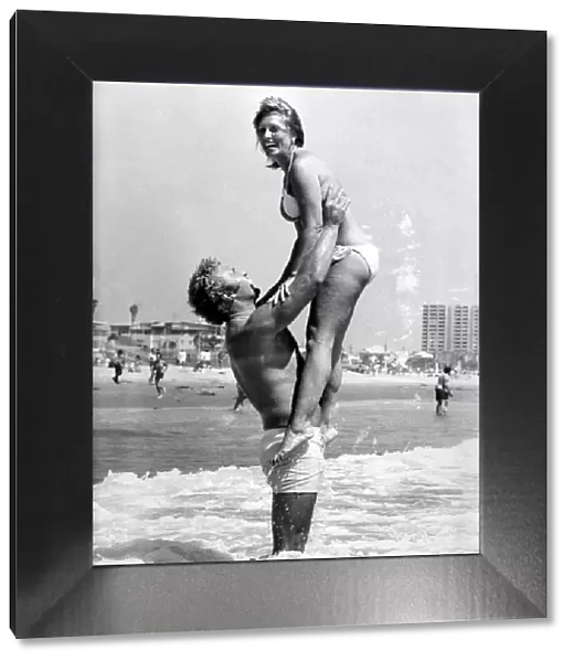 British heavyweight boxer Joe Bugner and Morlin Carter playing in the sea