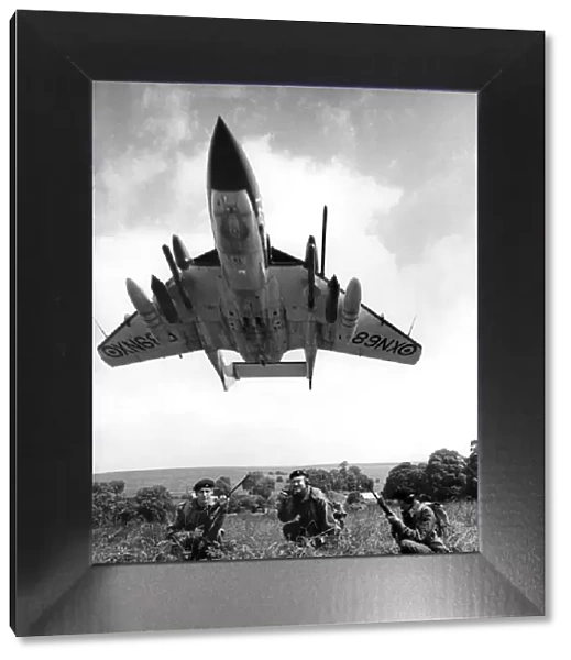 A Sea Vixen swoops over soldiers seen here on exercise on Salisbury Plain