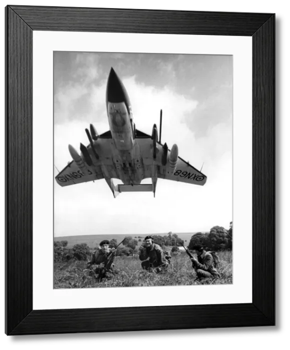 Framed Print : A Sea Vixen swoops over soldiers seen here on exercise on Salisbury Plain Framed Print : A Sea Vixen swoops over soldiers seen here on exercise on Salisbury Plain