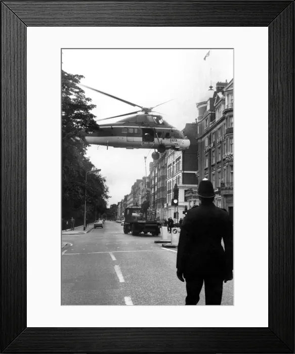 Framed Print : Good Morning Officer, Won t Be A Minute: A policeman keeps a careful watch as a Framed Print : Good Morning Officer, Won t Be A Minute: A policeman keeps a careful watch as a