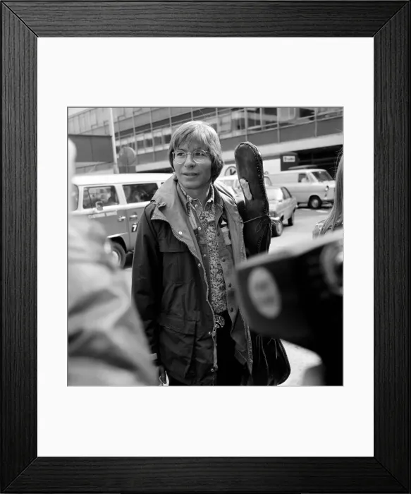 Framed Print : John Denver: U. S. singer seen here at London Airport with his guitar. April 1976 Framed Print : John Denver: U. S. singer seen here at London Airport with his guitar. April 1976