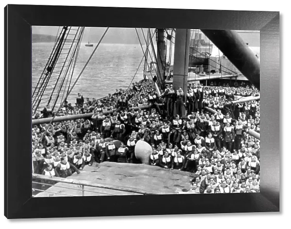 Crowded decks following a drill on board a British troopship carrying soldiers of