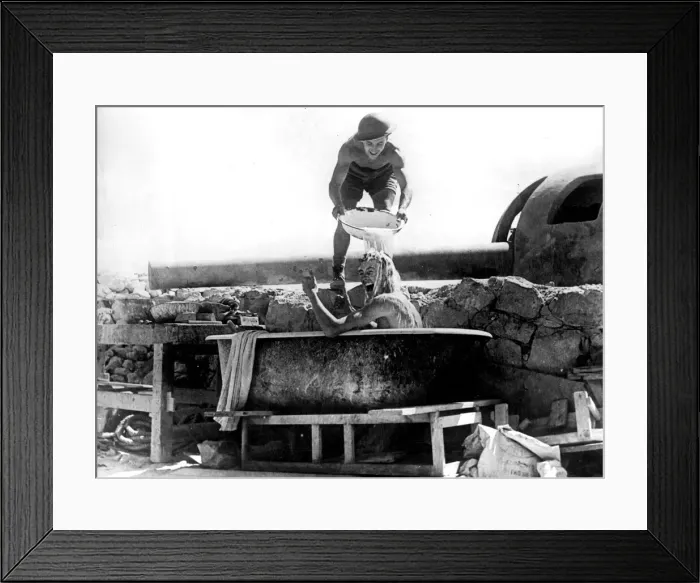Framed Print : One of the crew of the coastal defence guns in Tobruk, takes a bath under the shadow of Framed Print : One of the crew of the coastal defence guns in Tobruk, takes a bath under the shadow of