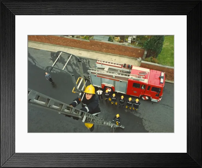 Framed Print : A training exercise in the centre of Newcastle - firefighter Sean McHee shows how to