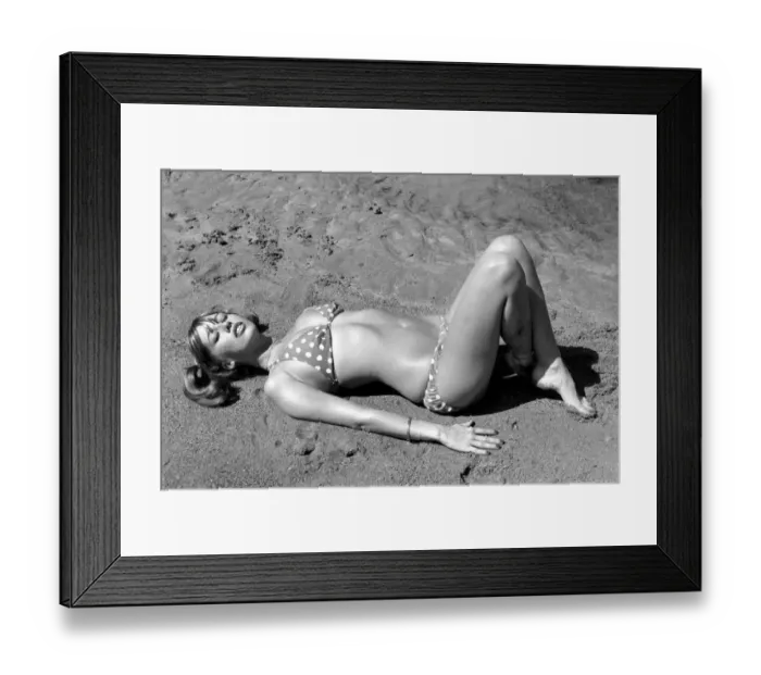 Framed Print : Model wearing a polka dot bikini as she lies on a beach in Africa April 1975
