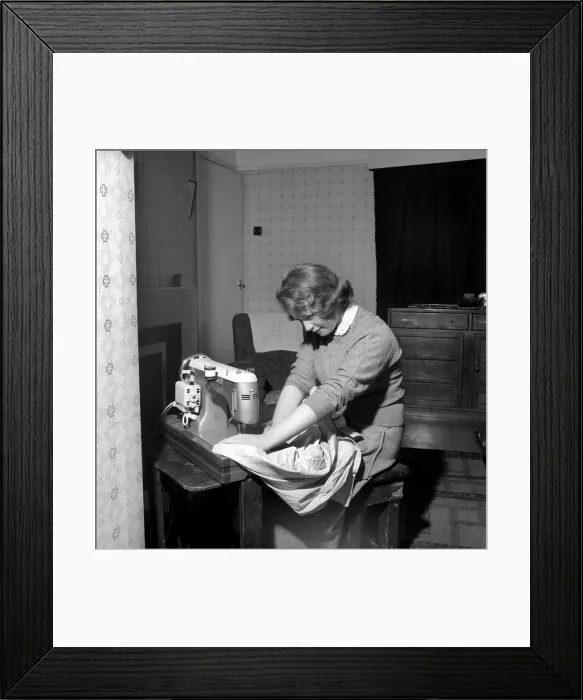 Framed Print : Woman at sewing machine: Mrs. John Theakeston seen here making a dress Framed Print : Woman at sewing machine: Mrs. John Theakeston seen here making a dress
