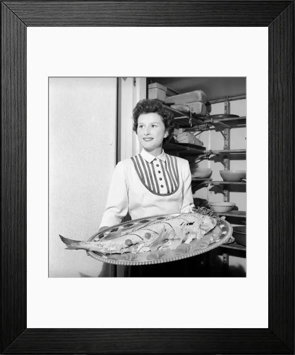 Framed Print : Woman holding fish on a platter. 1957 A17a Framed Print : Woman holding fish on a platter. 1957 A17a