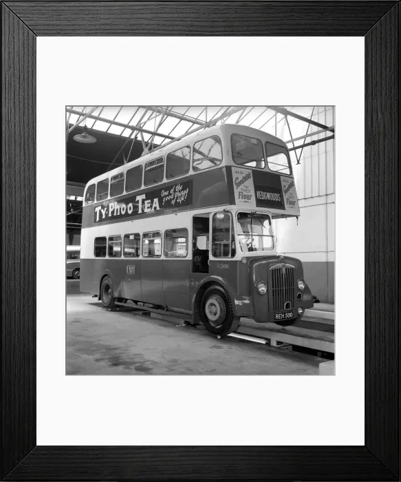 Framed Print : Bus balanced on Cups from the Josiah Wedgewood and Son fine China company to demonstrate Framed Print : Bus balanced on Cups from the Josiah Wedgewood and Son fine China company to demonstrate