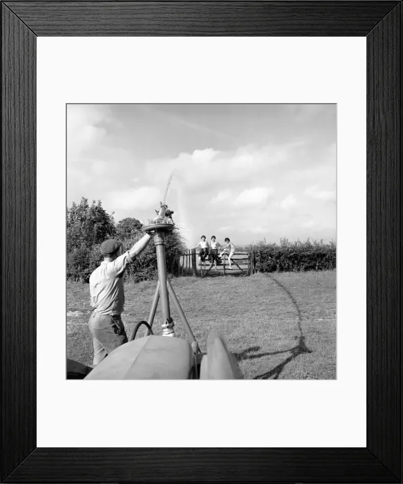 Framed Print : Inventions: The Rain Gun': A farmer seen here testing a new kind of irrigation Framed Print : Inventions: The Rain Gun': A farmer seen here testing a new kind of irrigation