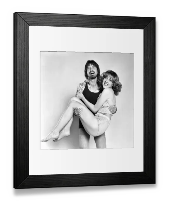 Framed Print : Couple wearing 1970s fashion. The woman wearing a matching top Framed Print : Couple wearing 1970s fashion. The woman wearing a matching top