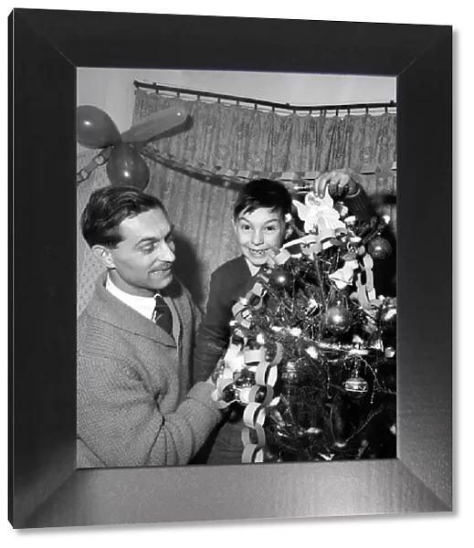 Man and boy dressing the christmas tree. Mr. Frederick Martin 44 Grey Tower Avenue