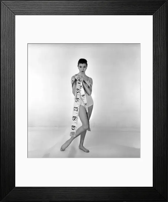 Framed Print : Model Gay Protheroe with outsize tape-measure. December 1956