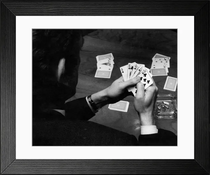 Framed Print : A man holding his hand of cards, a royal flush, while playing poker. February 1972 Framed Print : A man holding his hand of cards, a royal flush, while playing poker. February 1972