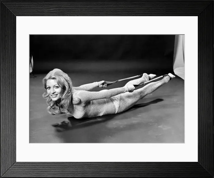Framed Print : Woman lying on the floor doing slimming exercises. January 1971 Framed Print : Woman lying on the floor doing slimming exercises. January 1971