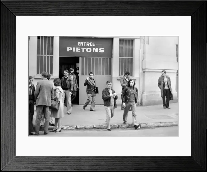 Framed Print : Renault factory workers leaving at the end of a shift through a door marked Framed Print : Renault factory workers leaving at the end of a shift through a door marked