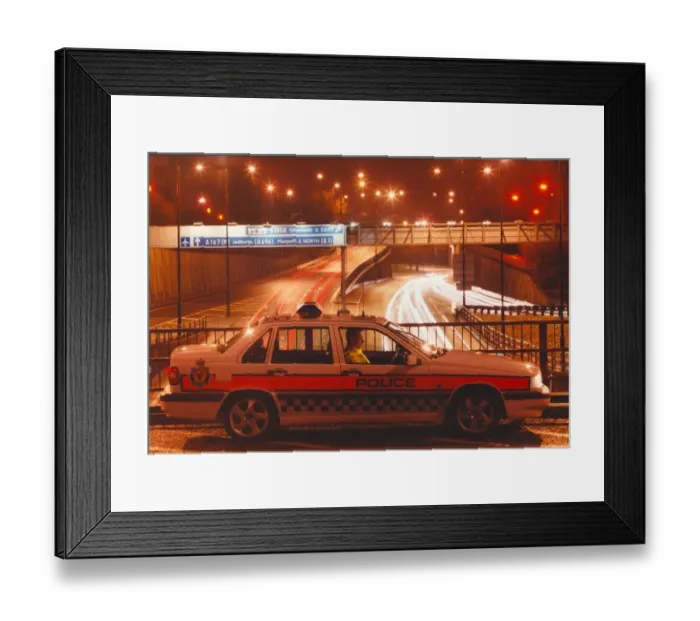 Framed Print : A police officer watches the traffic whizz by in his patrol car 01  /  06  /  95 circa