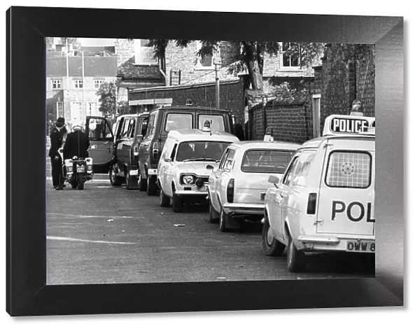 A line of police cars and vans in a Newcastle Street
