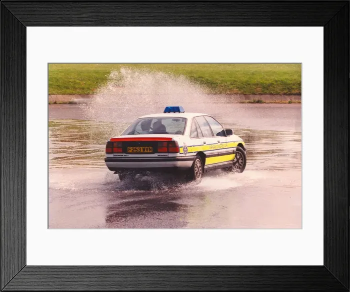 Framed Print : A police patrol car does a skid through a puddle Framed Print : A police patrol car does a skid through a puddle