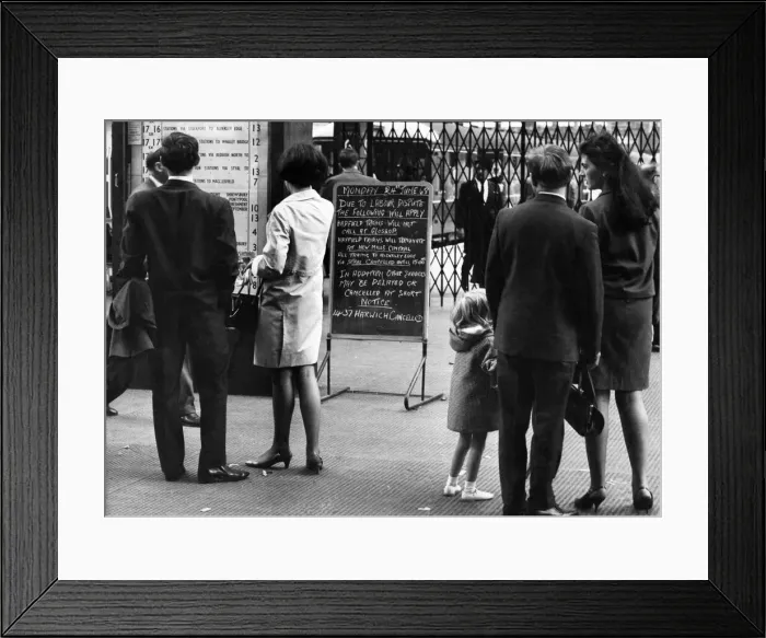 Framed Print : Customers read notice of a strike at a London railways station. June 1968 Framed Print : Customers read notice of a strike at a London railways station. June 1968