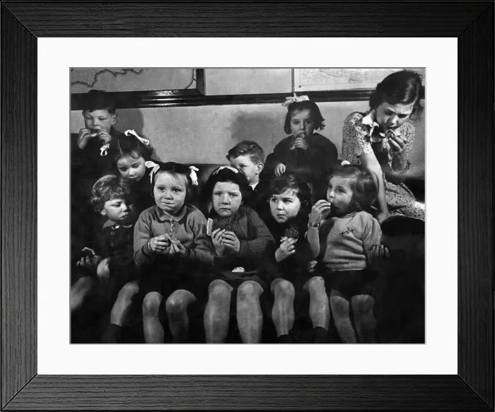 Framed Print : My! It looks good but tastes better. Children seen here enjoy a piece of fruit cake Framed Print : My! It looks good but tastes better. Children seen here enjoy a piece of fruit cake