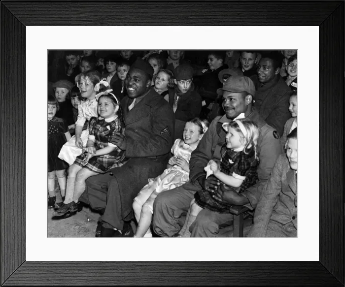 Framed Print : Happy picture of the children with black American soldiers enjoying a programme of Framed Print : Happy picture of the children with black American soldiers enjoying a programme of