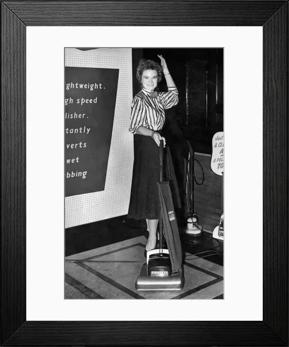 Framed Print : Miss Doreen Haines of Kensington. poses with a vacuum cleaner at Fillerys store Framed Print : Miss Doreen Haines of Kensington. poses with a vacuum cleaner at Fillerys store