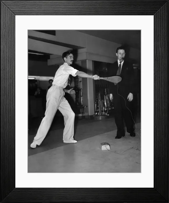 Framed Print : A man taking part in the Basque paddle and ball game of Jokari at an exhibition Framed Print : A man taking part in the Basque paddle and ball game of Jokari at an exhibition