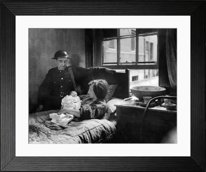 Framed Print : Warden Bill Watson at the bedside of Mrs. R. Foster. With bombs falling round Framed Print : Warden Bill Watson at the bedside of Mrs. R. Foster. With bombs falling round