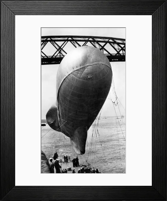 Framed Print : A balloon in tow from a warship as it passed under the Forth Bridge Framed Print : A balloon in tow from a warship as it passed under the Forth Bridge