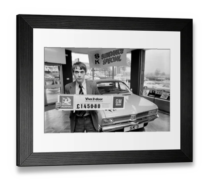 Framed Print : A car dealer putting cars on sale in his garage forecourt in Brighton. May 1975