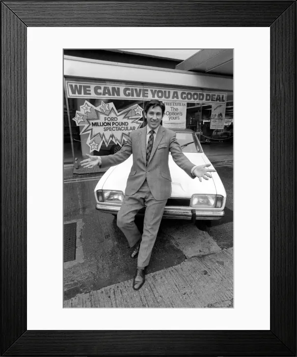 Framed Print : A car dealer putting cars on sale in his garage forecourt in Brighton. May 1975 Framed Print : A car dealer putting cars on sale in his garage forecourt in Brighton. May 1975