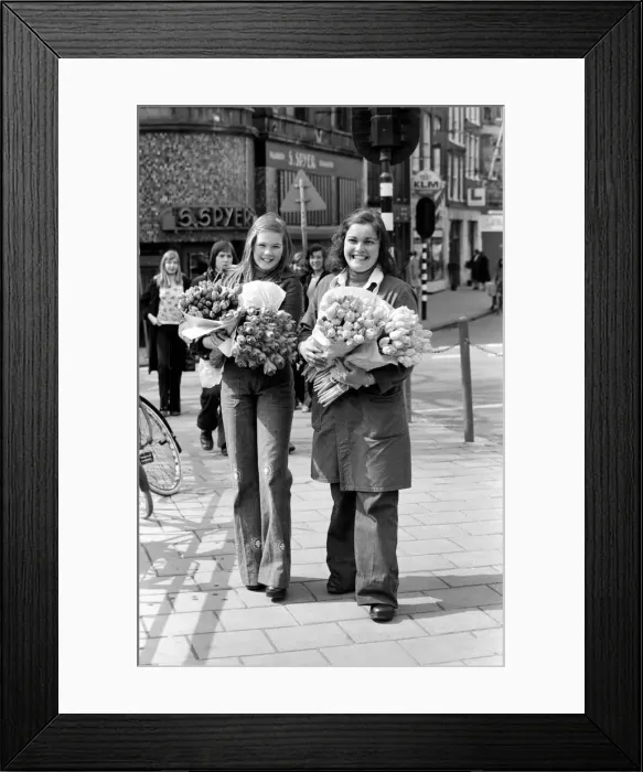 Framed Print : Two young girls of Amsterdam holding bunches of tulips during the season May 1975 Framed Print : Two young girls of Amsterdam holding bunches of tulips during the season May 1975