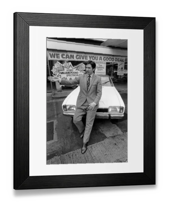 Framed Print : A car dealer putting cars on sale in his garage forecourt in Brighton. May 1975 Framed Print : A car dealer putting cars on sale in his garage forecourt in Brighton. May 1975