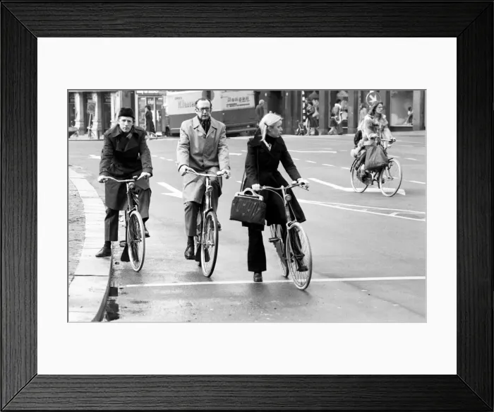 Framed Print : People getting around the town by bicycle in Rotterdam, Holland. May 1975 Framed Print : People getting around the town by bicycle in Rotterdam, Holland. May 1975
