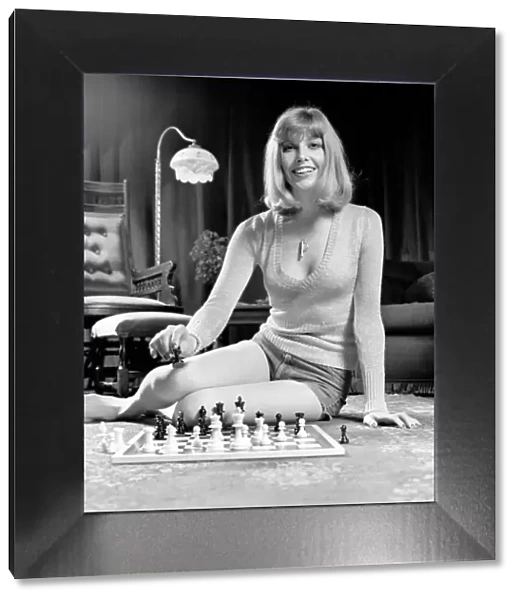 Woman pictured at home playing a game of chess. May 1975